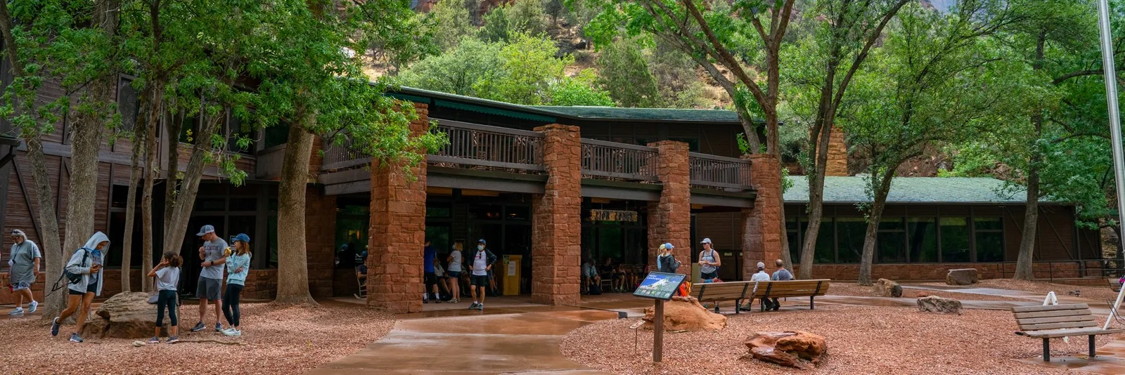 Visitors outside the stone-and-timber main building at Zion Lodge.