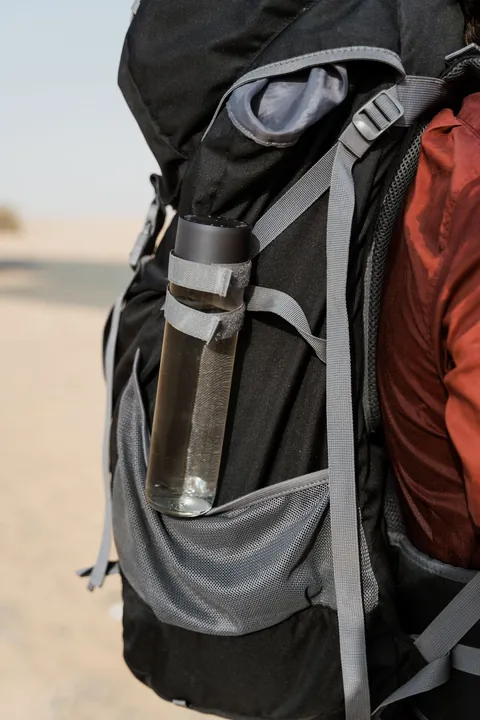 Water bottle secured to a hiking backpack - real gear photograph